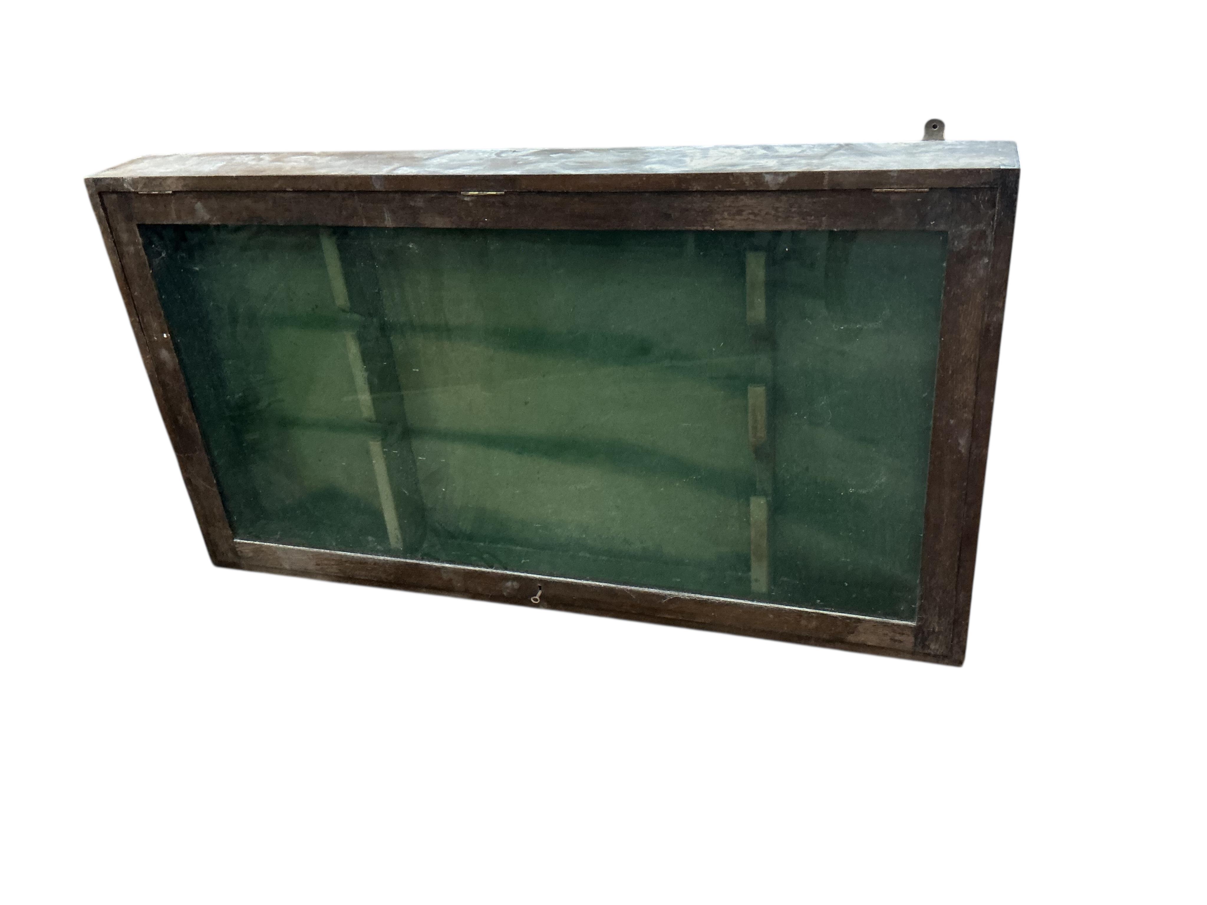 An oak hanging gun cabinet, width 134cm, depth 14cm, height 74cm